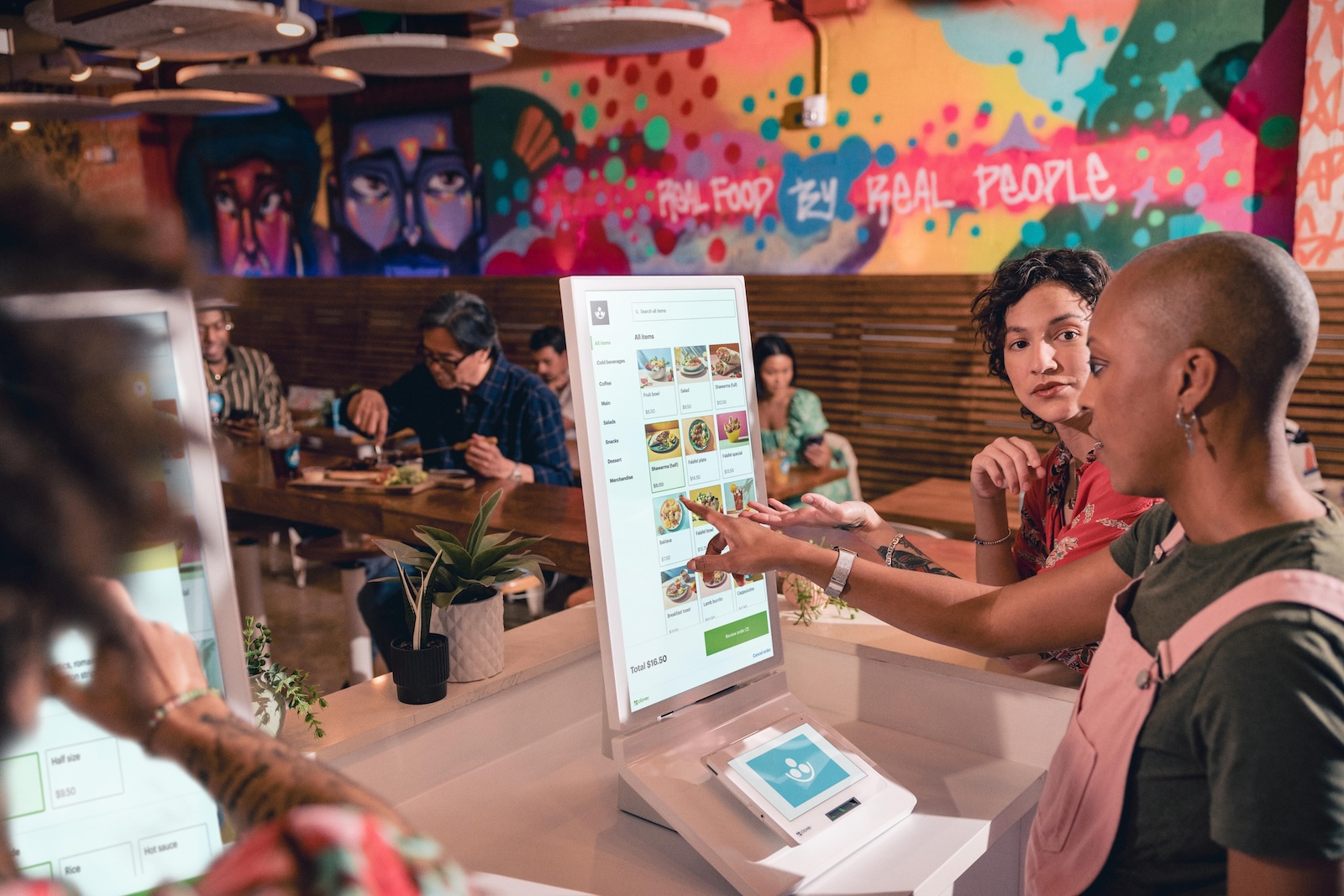 Clientes fazendo pedido em restaurante utilizando a Clover Kiosk
